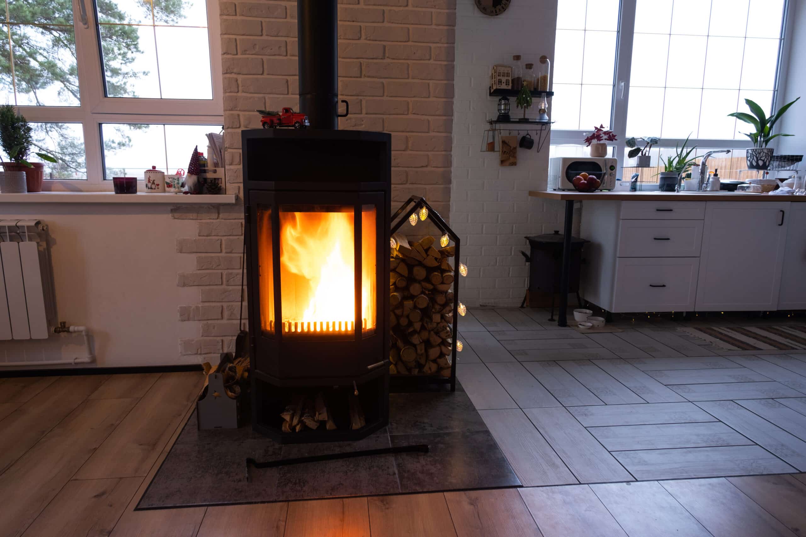 black metal stove fireplace with wood in a woodpile the interi