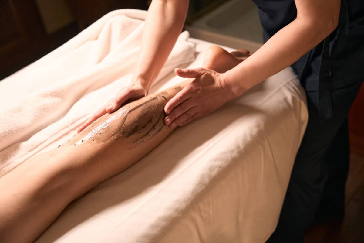 professional massotherapist giving anti cellulite massage to patient