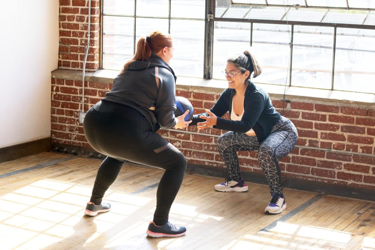 women doing squats in fitness class